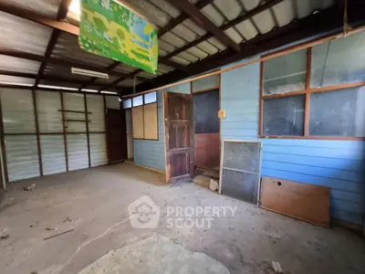 Spacious rustic storage area with wooden walls and metal roof