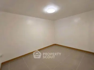 Minimalist empty room with tiled floor and bright lighting, perfect for customization.