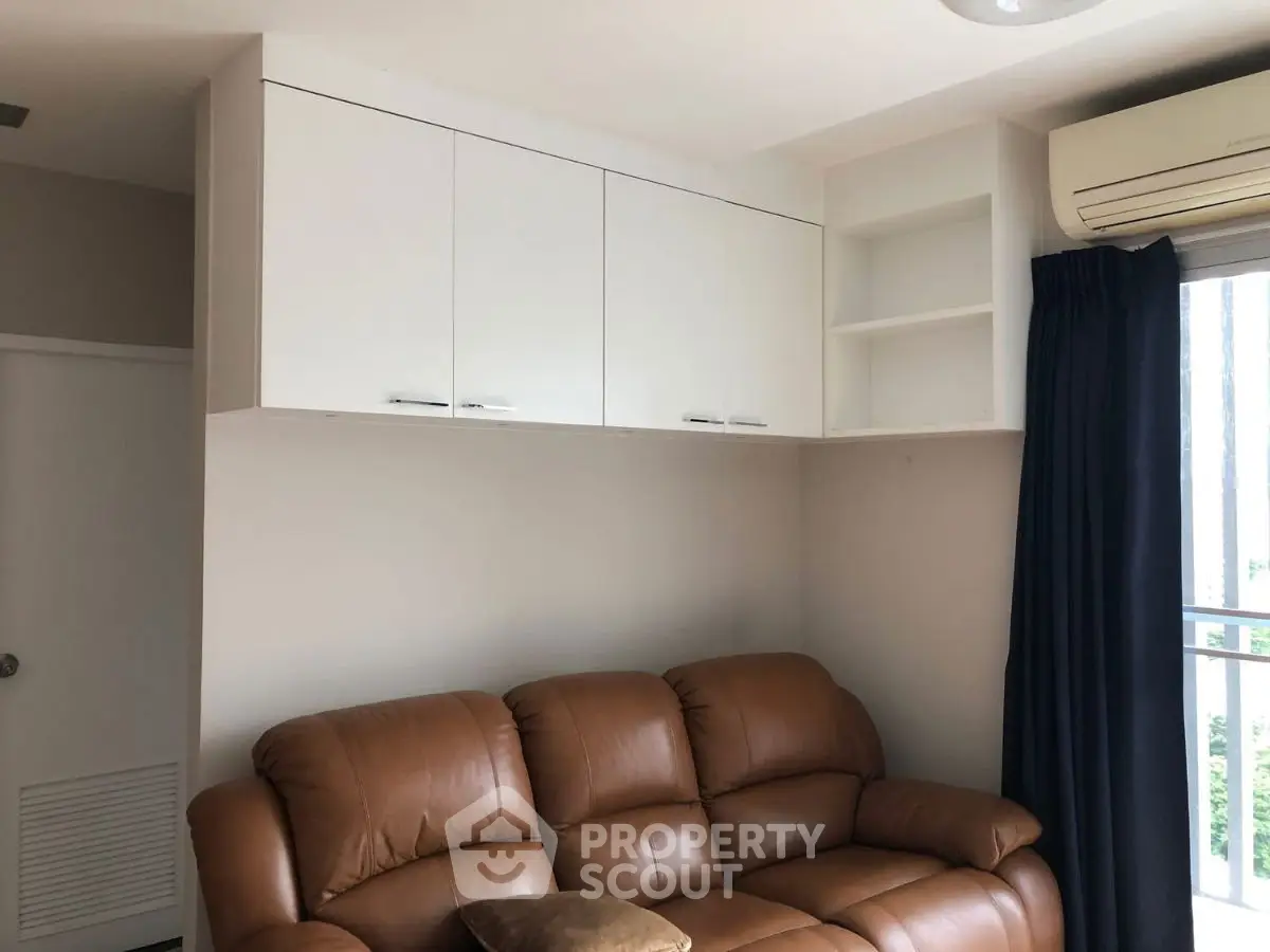 Cozy living room with leather sofa and modern storage cabinets