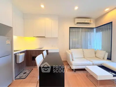 Modern open-layout living room with sleek kitchen and cozy seating area