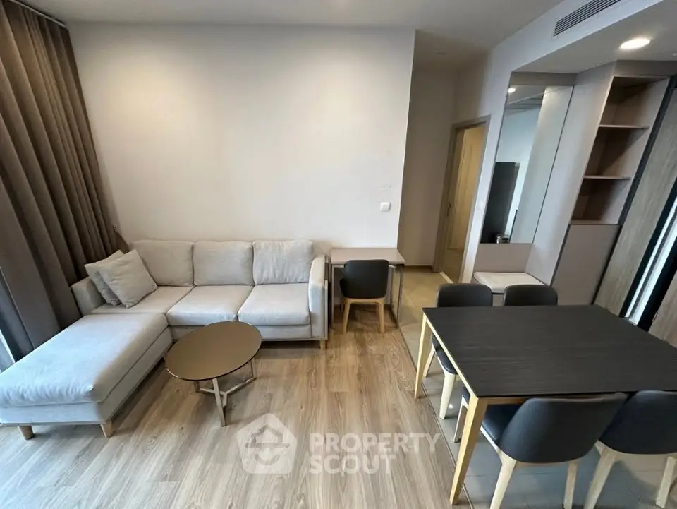Modern living room with cozy sofa and dining area in stylish apartment