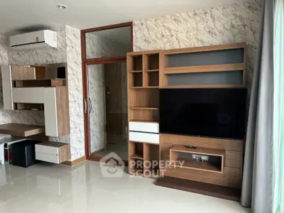 Modern living room with stylish wooden shelving and TV unit, marble accent wall, and air conditioning.