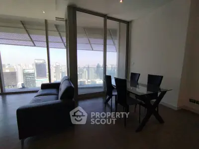 Modern living room with glass dining table and stunning city view