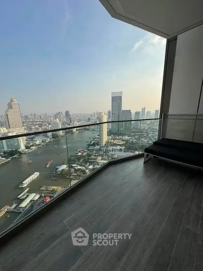 Stunning high-rise balcony with panoramic city and river views, perfect for urban living.