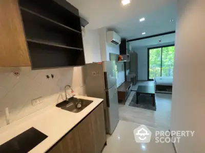 Modern studio apartment with open kitchen and scenic view