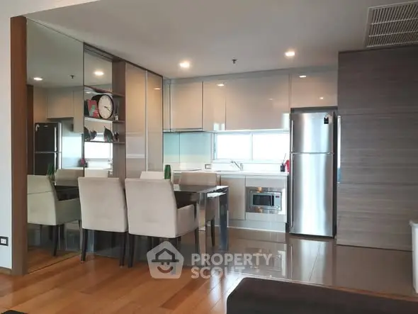 Modern kitchen with sleek cabinetry and dining area in a stylish apartment