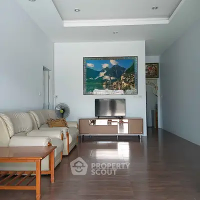 Spacious living room with modern decor and comfortable seating in a stylish home.