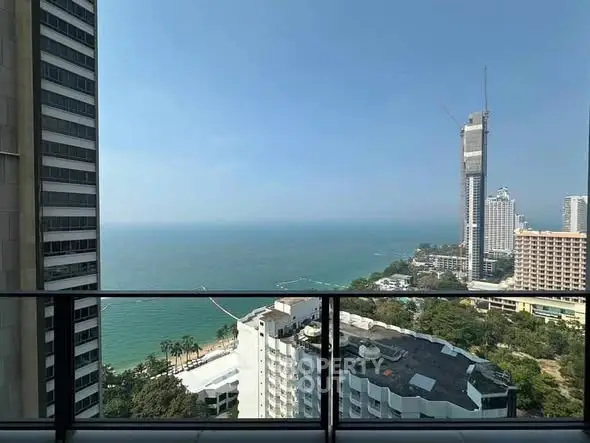 Stunning high-rise ocean view from a modern balcony in a luxury apartment.