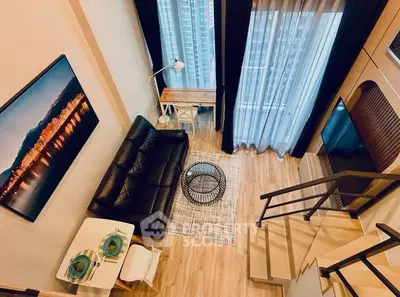 Modern loft-style living room with high ceilings and large windows, featuring a cozy seating area and stylish decor.