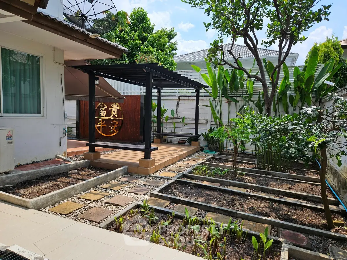 Charming garden with pergola in a serene residential backyard setting, perfect for relaxation and outdoor gatherings.