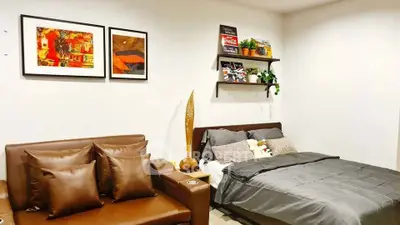 Cozy bedroom with stylish decor and comfortable seating area