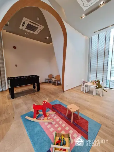 Modern playroom with wooden toys and colorful rug in a stylish apartment building