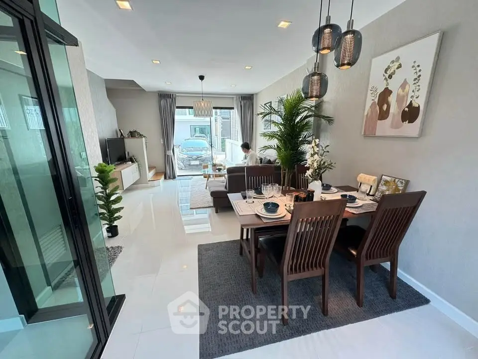 Elegant open-plan living and dining area with modern decor and natural light.