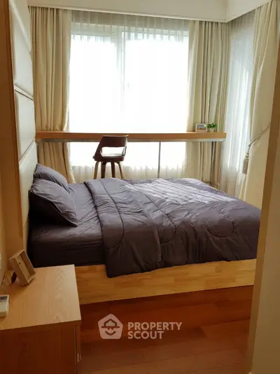 Cozy bedroom with modern decor and large windows for natural light