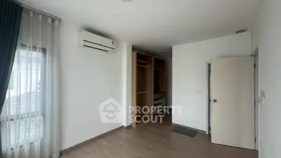 Spacious bedroom with built-in wardrobe and air conditioning unit