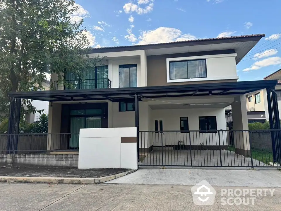 Modern two-story house with spacious driveway and balcony