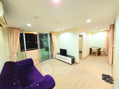 Spacious living room with modern decor and balcony access in urban apartment