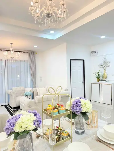 Luxurious living room with elegant chandelier and stylish decor, perfect for modern living.