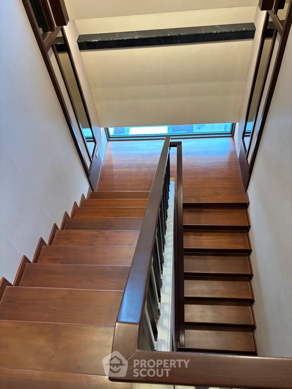 Elegant wooden staircase with modern design and natural light, perfect for contemporary homes.