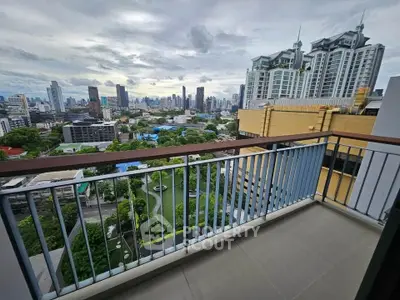 Stunning cityscape view from a spacious balcony in a high-rise apartment.