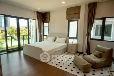 Spacious bedroom with large windows and modern decor in a luxury home
