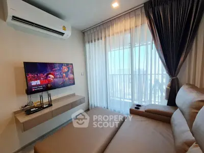 Modern living room with sleek sofa, wall-mounted TV, and large window with city view.
