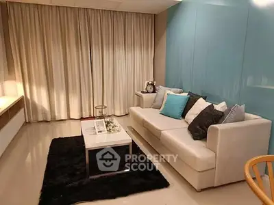 Modern living room with stylish sofa, elegant decor, and ambient lighting for a cozy atmosphere.