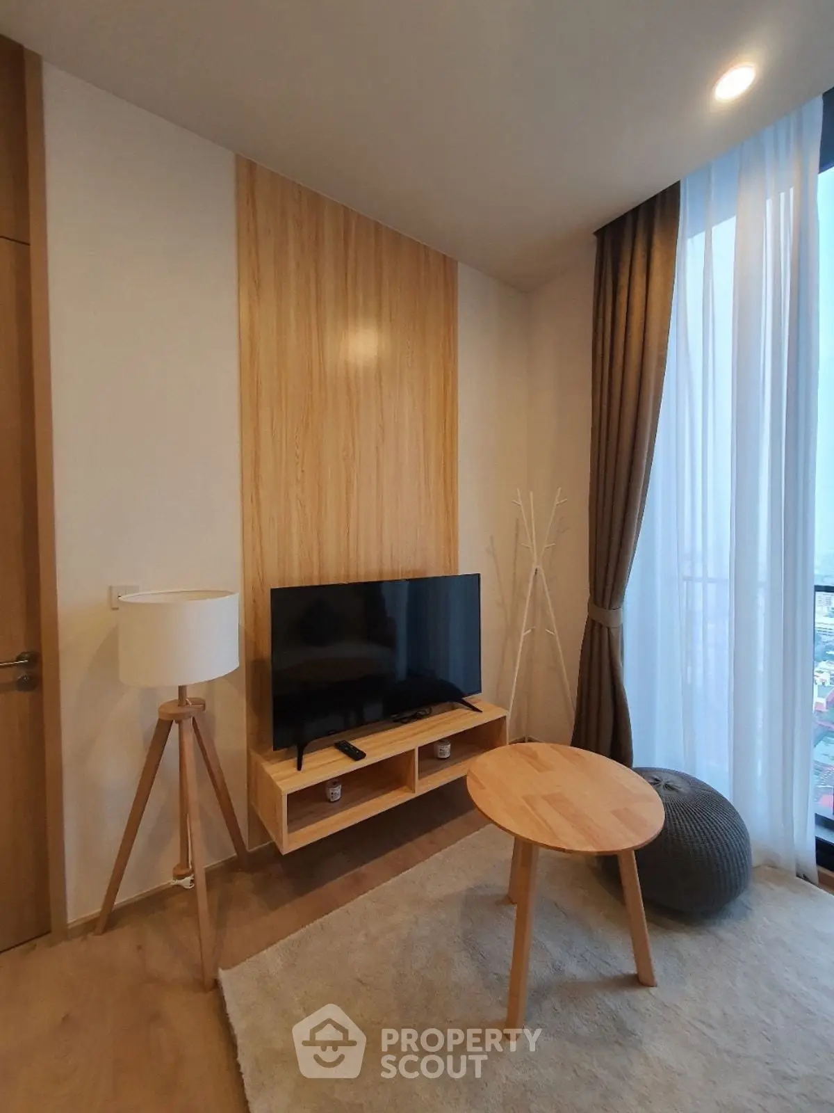 Modern living room with stylish wooden decor and large window view