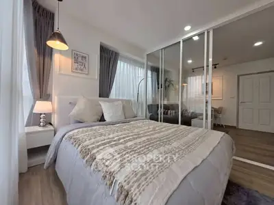 Modern bedroom with cozy decor and glass partition in stylish apartment.