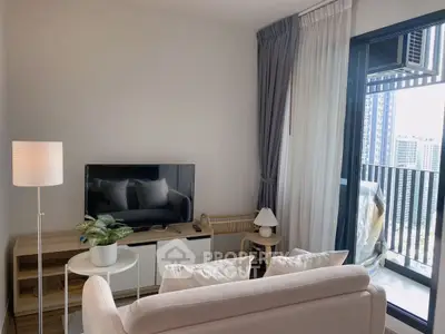 Modern living room with balcony view, stylish furniture, and natural light.