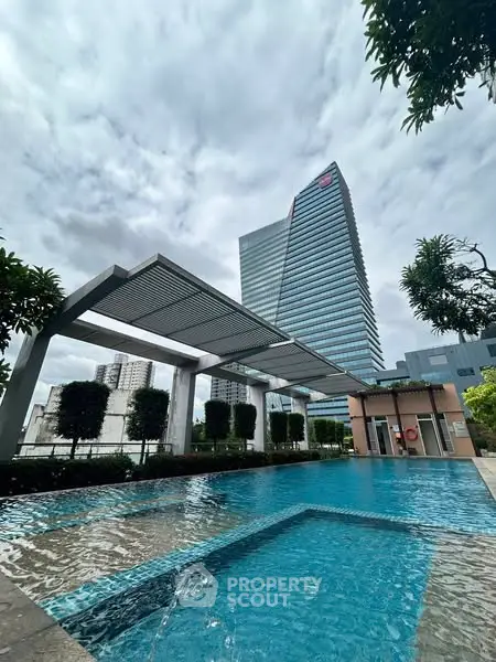 Luxurious urban pool with modern skyscraper backdrop, perfect for city living.