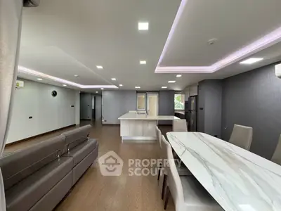Spacious modern living room with open kitchen and elegant dining area