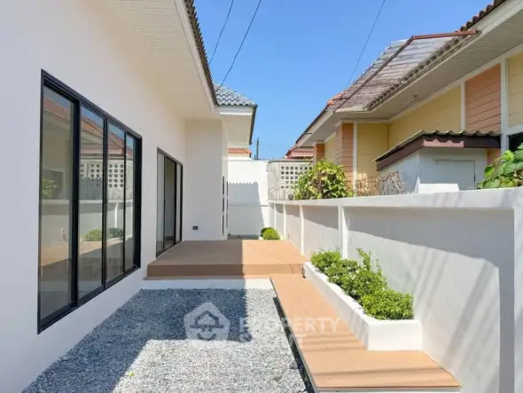Modern exterior view of a stylish home with clean lines and a minimalist garden.