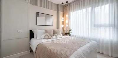 Elegant bedroom with modern decor, large window, and cozy bedding in a stylish apartment.