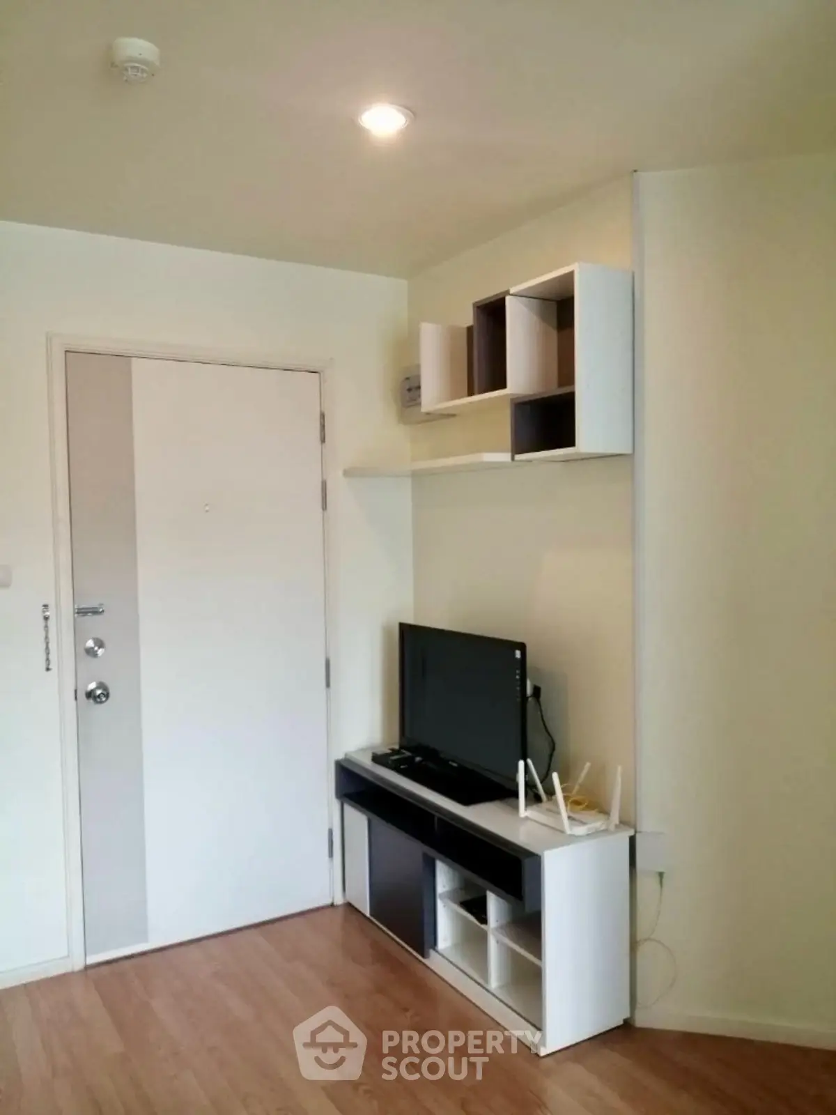 Modern living room with sleek TV stand and wall shelves