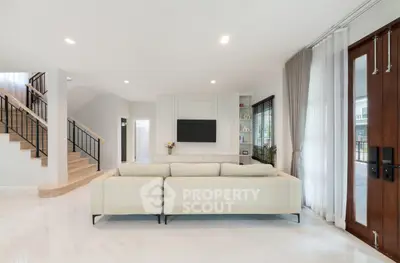 Spacious modern living room with elegant staircase and natural light