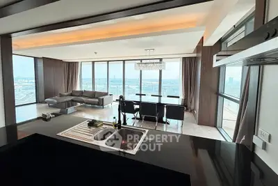 Luxurious open-plan living room with panoramic city views and modern furnishings.