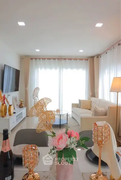 Elegant living room with modern decor, large windows, and stylish furniture, perfect for relaxation and entertainment.