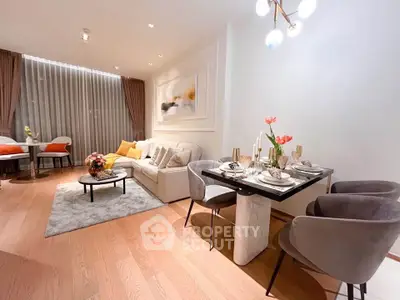 Elegant living room with modern decor and dining area, featuring cozy seating and stylish lighting.