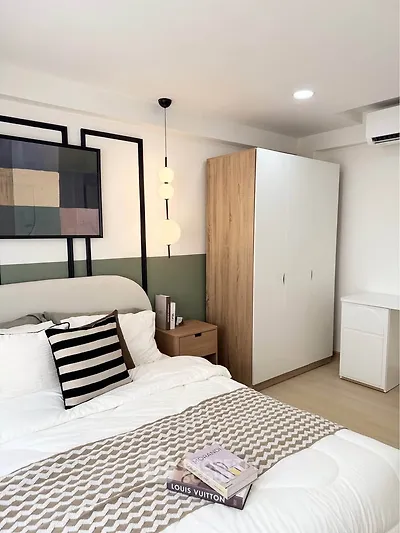 Modern bedroom with stylish decor and cozy ambiance, featuring a comfortable bed and sleek wardrobe.