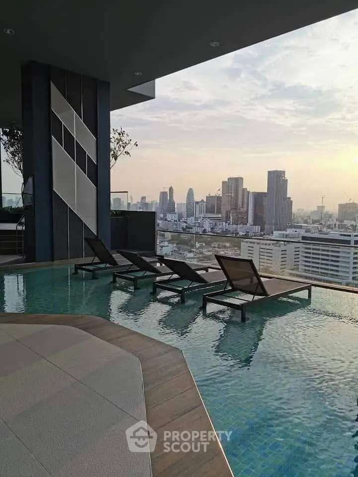 Luxurious rooftop pool with stunning city skyline view, perfect for relaxation and leisure in urban living.