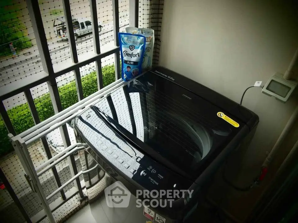Modern washing machine on balcony with city view, perfect for urban living convenience.