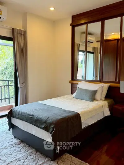 Cozy bedroom with balcony access and elegant decor