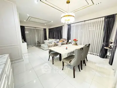 Luxurious open-plan living and dining area with elegant furnishings and modern decor.