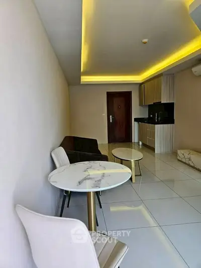 Modern living room with sleek furniture and open kitchen layout