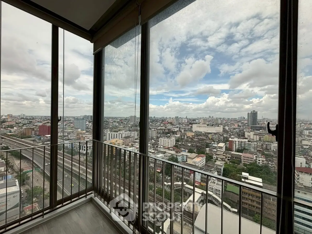 Stunning cityscape view from a high-rise balcony with expansive skyline and urban landscape.