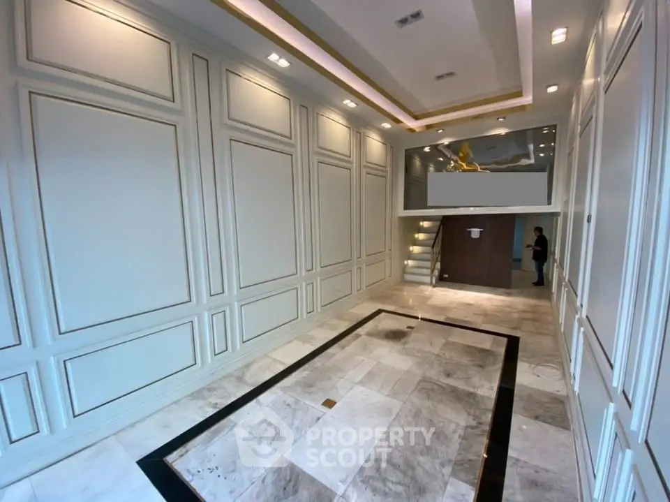 Luxurious building entrance with elegant marble flooring and modern lighting