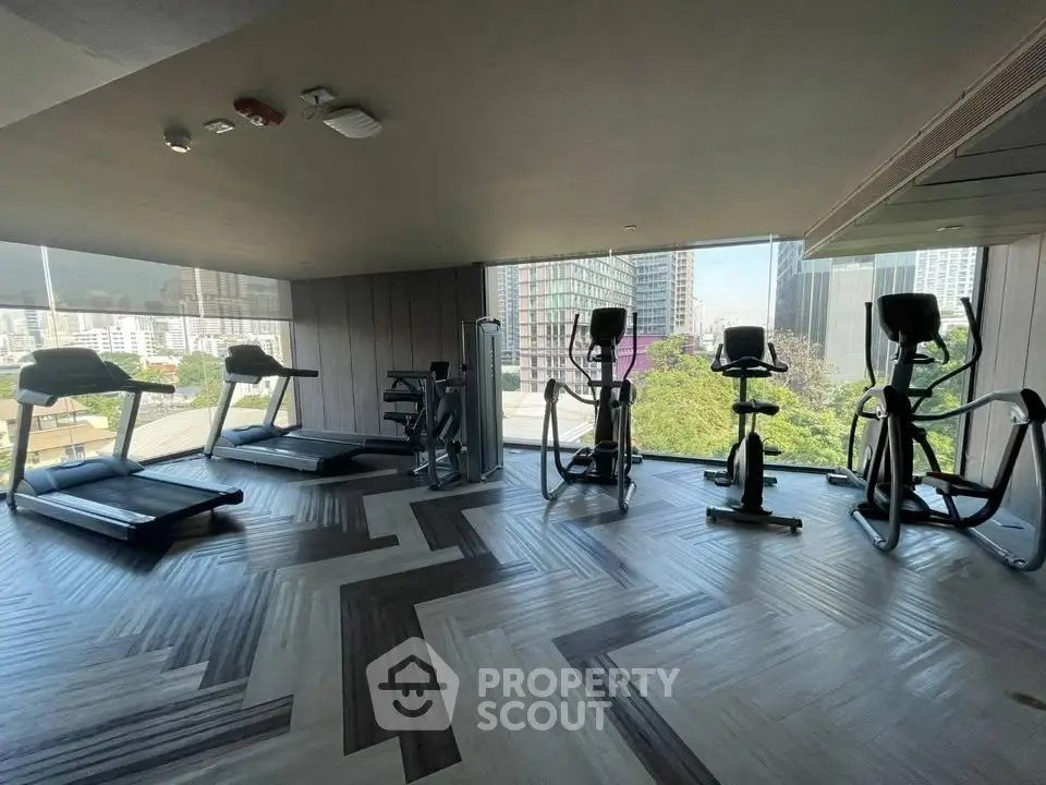Modern gym with city view and state-of-the-art fitness equipment