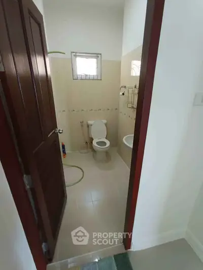 Compact bathroom with modern fixtures and natural light, ideal for efficient space utilization.