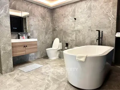 Luxurious modern bathroom with elegant freestanding bathtub and sleek fixtures.
